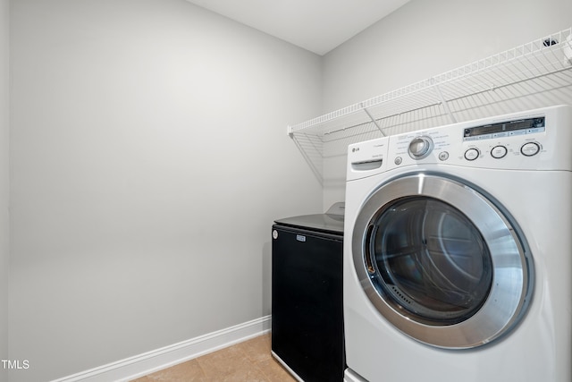 400 Swann Trl, Clayton, NC 27527 - laundry room with washer and dryer and light tile patterned flooring