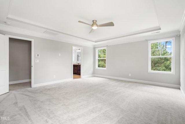400 Swann Trl, Clayton, NC 27527 - unfurnished bedroom featuring a raised ceiling, crown molding, light carpet, and multiple windows