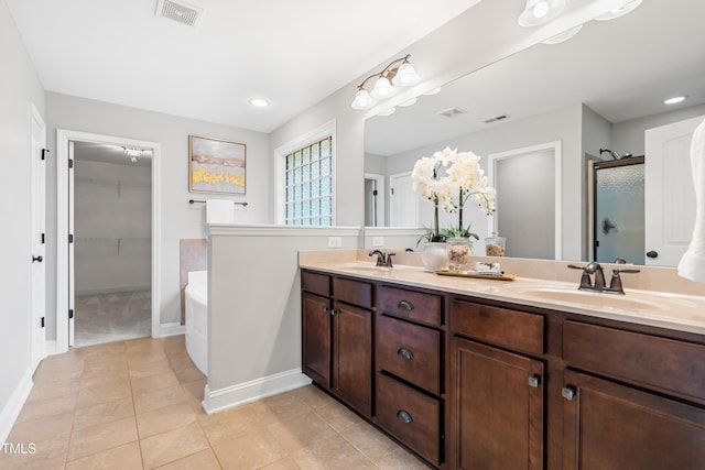 400 Swann Trl, Clayton, NC 27527 - bathroom with a stall shower, tile patterned floors, a bath, double vanity, and recessed lighting