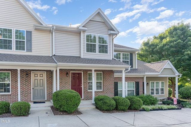 7819 River Field Dr, Raleigh, NC 27616 - view of front facade with brick siding, covered porch, and a shingled roof