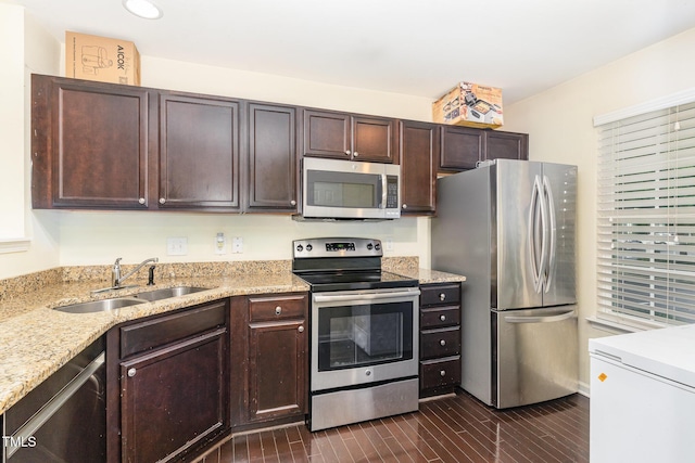 7819 River Field Dr, Raleigh, NC 27616 - kitchen with appliances with stainless steel finishes, dark brown cabinetry, light stone counters, recessed lighting, and dark wood-style flooring