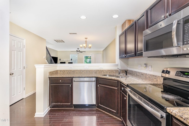 7819 River Field Dr, Raleigh, NC 27616 - kitchen with stainless steel appliances, a peninsula, dark brown cabinets, and recessed lighting