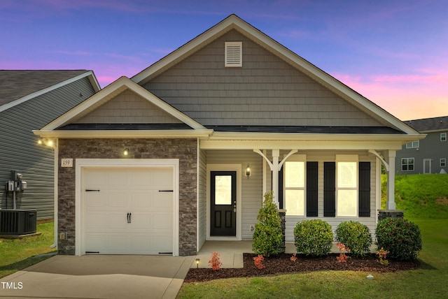 159 Forsyth Pkwy, Clayton, NC 27520 - view of front facade featuring stone siding, a garage, driveway, and covered porch