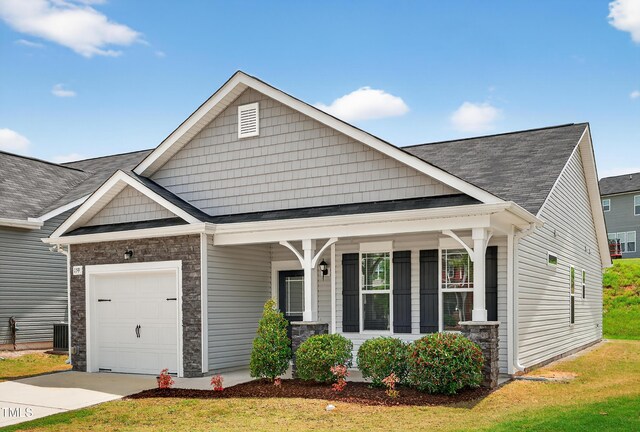 159 Forsyth Pkwy, Clayton, NC 27520 - craftsman inspired home featuring a porch, a garage, stone siding, driveway, and a front lawn