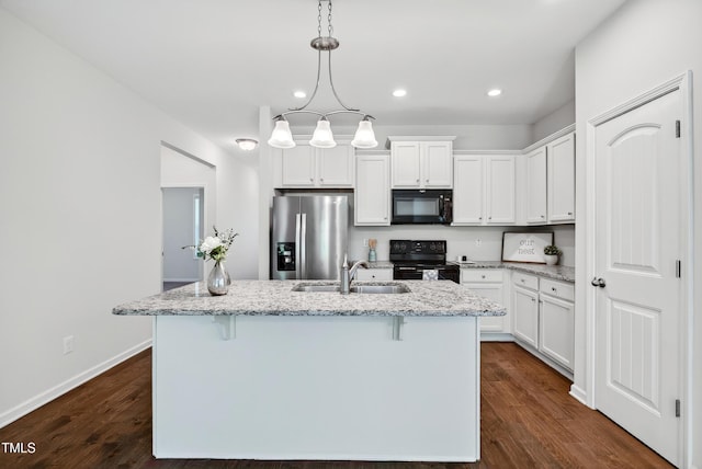 159 Forsyth Pkwy, Clayton, NC 27520 - kitchen with black appliances, recessed lighting, a center island with sink, white cabinets, and a breakfast bar area