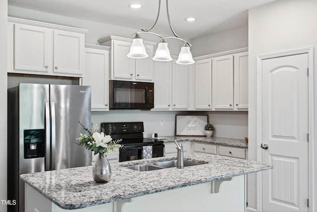 159 Forsyth Pkwy, Clayton, NC 27520 - kitchen featuring black appliances, an island with sink, white cabinets, a kitchen bar, and hanging light fixtures