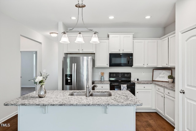 159 Forsyth Pkwy, Clayton, NC 27520 - kitchen featuring black appliances, a kitchen bar, white cabinets, and recessed lighting