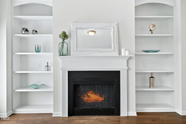 159 Forsyth Pkwy, Clayton, NC 27520 - detailed view of wood finished floors, built in shelves, and a warm lit fireplace
