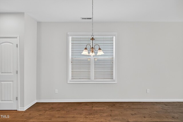159 Forsyth Pkwy, Clayton, NC 27520 - unfurnished dining area with a chandelier and wood finished floors
