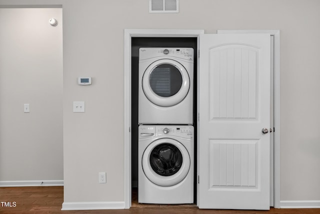 159 Forsyth Pkwy, Clayton, NC 27520 - washroom featuring stacked washer and clothes dryer and wood finished floors