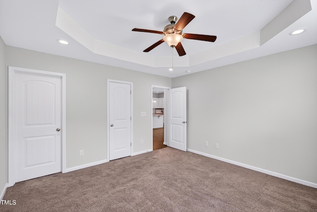 159 Forsyth Pkwy, Clayton, NC 27520 - unfurnished bedroom featuring a tray ceiling, carpet flooring, recessed lighting, and a ceiling fan