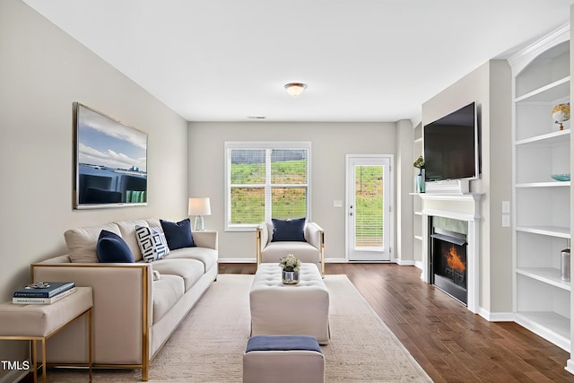 159 Forsyth Pkwy, Clayton, NC 27520 - living area with dark wood-type flooring and a warm lit fireplace