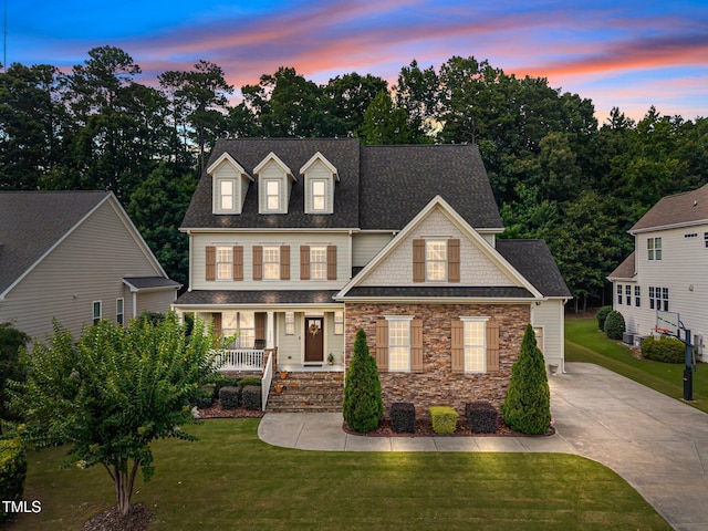 3036 Lawson Walk Way, Rolesville, NC 27571 - view of front facade featuring covered porch, a front lawn, driveway, roof with shingles, and stone siding