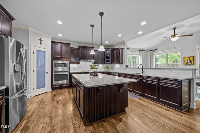 3036 Lawson Walk Way, Rolesville, NC 27571 - kitchen featuring appliances with stainless steel finishes, a center island, tasteful backsplash, crown molding, and dark wood-style floors