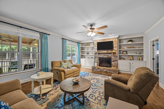 3036 Lawson Walk Way, Rolesville, NC 27571 - living room with a ceiling fan, wood finished floors, crown molding, a stone fireplace, and built in shelves