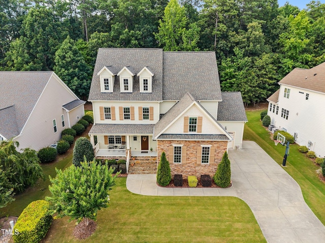 3036 Lawson Walk Way, Rolesville, NC 27571 - view of front of house with a porch, stone siding, concrete driveway, and roof with shingles