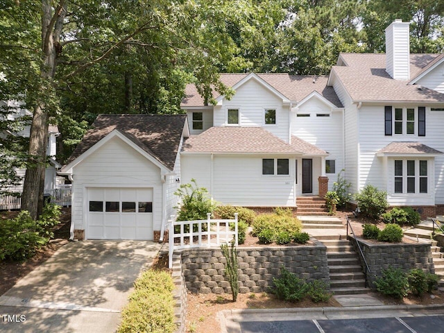 3811 Carnegie Ln, Raleigh, NC 27612 - view of front of house featuring an attached garage, driveway, stairs, and a shingled roof