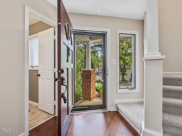 3811 Carnegie Ln, Raleigh, NC 27612 - foyer entrance featuring ornate columns, wood finished floors, and stairs