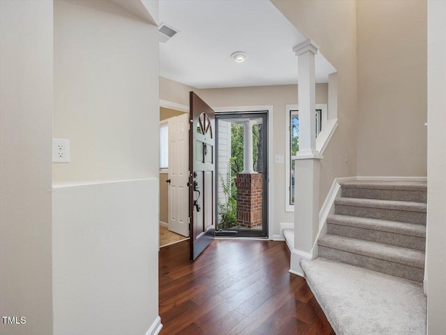 3811 Carnegie Ln, Raleigh, NC 27612 - foyer entrance with decorative columns, stairway, and dark wood-type flooring