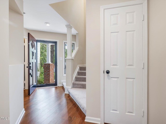 3811 Carnegie Ln, Raleigh, NC 27612 - foyer with decorative columns, dark wood-style flooring, and stairs