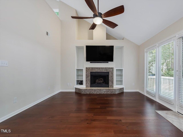 3811 Carnegie Ln, Raleigh, NC 27612 - unfurnished living room featuring a ceiling fan, dark wood finished floors, high vaulted ceiling, built in features, and a tiled fireplace