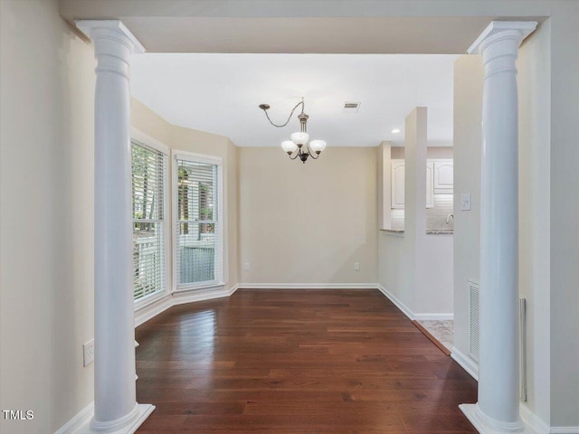 3811 Carnegie Ln, Raleigh, NC 27612 - empty room with wood finished floors, a chandelier, decorative columns, and recessed lighting