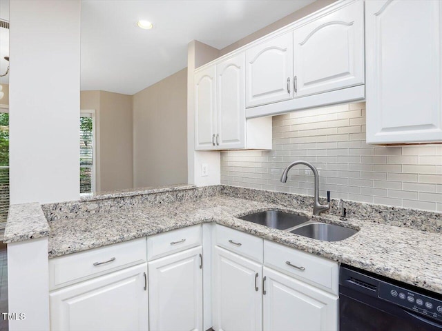 3811 Carnegie Ln, Raleigh, NC 27612 - kitchen featuring black dishwasher, decorative backsplash, white cabinetry, light stone countertops, and a peninsula