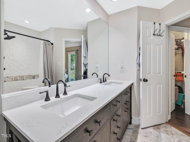 3811 Carnegie Ln, Raleigh, NC 27612 - full bath featuring a walk in closet, double vanity, a shower with curtain, and recessed lighting