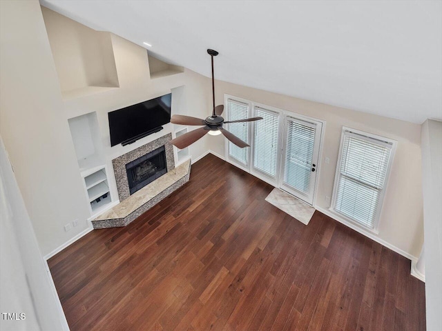3811 Carnegie Ln, Raleigh, NC 27612 - unfurnished living room with ceiling fan, a fireplace with raised hearth, and dark wood-style floors