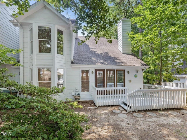 3811 Carnegie Ln, Raleigh, NC 27612 - view of front facade with roof with shingles, a chimney, and a deck