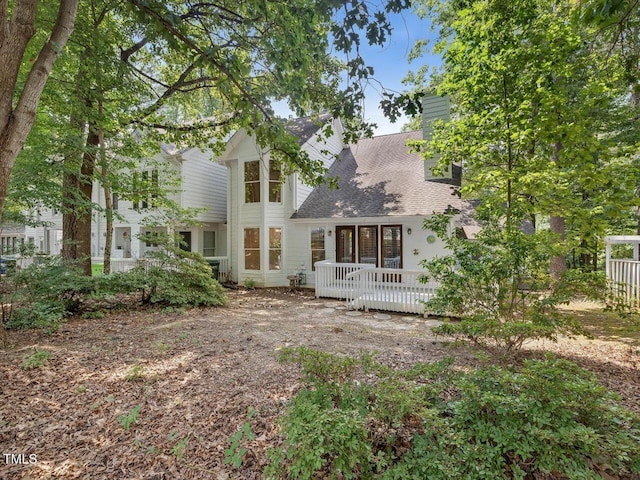 3811 Carnegie Ln, Raleigh, NC 27612 - rear view of property with a chimney, a wooden deck, and roof with shingles