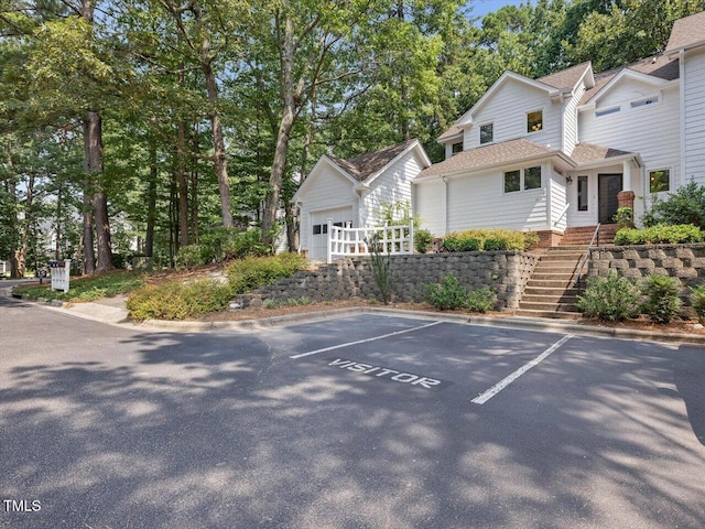 3811 Carnegie Ln, Raleigh, NC 27612 - view of front facade featuring an outdoor structure, uncovered parking, and stairs