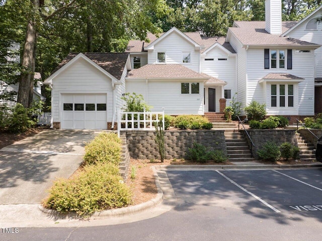 3811 Carnegie Ln, Raleigh, NC 27612 - view of front of property featuring stairway, a chimney, a garage, and roof with shingles