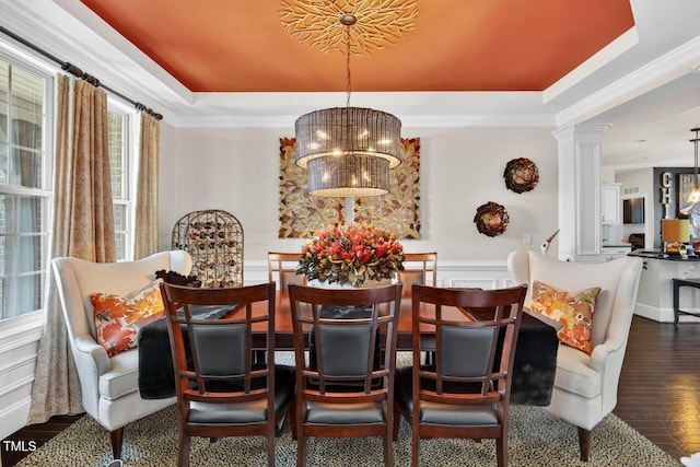 1806 Pattersons Mill Rd, Durham, NC 27703 - dining area featuring a tray ceiling, a chandelier, wood finished floors, decorative columns, and ornamental molding