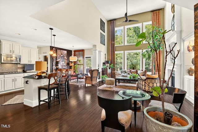 1806 Pattersons Mill Rd, Durham, NC 27703 - dining room with a high ceiling, ornate columns, dark wood-style floors, recessed lighting, and ceiling fan