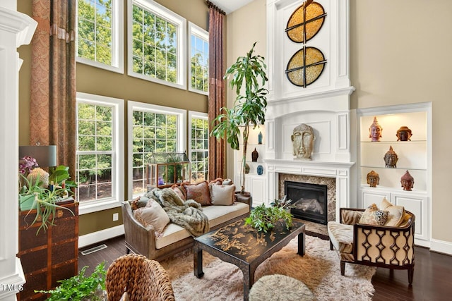 1806 Pattersons Mill Rd, Durham, NC 27703 - living room featuring a high end fireplace, dark wood-style floors, healthy amount of natural light, and a towering ceiling