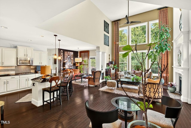 1806 Pattersons Mill Rd, Durham, NC 27703 - dining area with plenty of natural light, a fireplace with flush hearth, a high ceiling, dark wood finished floors, and decorative columns