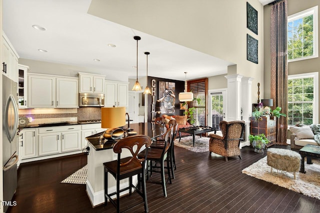 1806 Pattersons Mill Rd, Durham, NC 27703 - dining room featuring healthy amount of natural light, dark wood finished floors, a towering ceiling, and recessed lighting