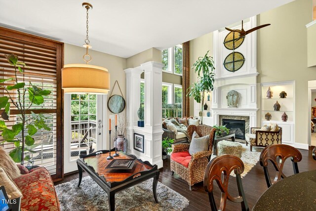 1806 Pattersons Mill Rd, Durham, NC 27703 - living room with decorative columns, a fireplace, and dark wood finished floors