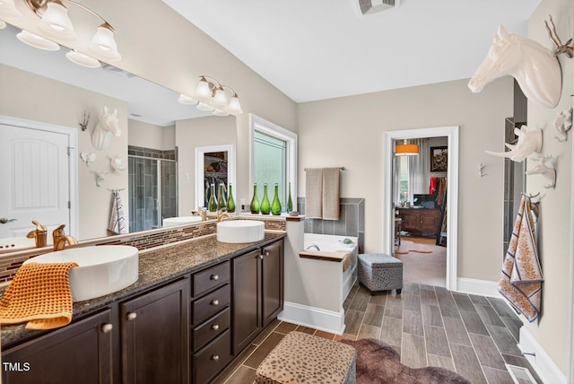 1806 Pattersons Mill Rd, Durham, NC 27703 - bathroom with double vanity, a stall shower, a garden tub, and healthy amount of natural light