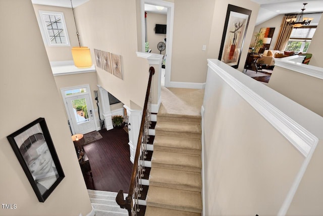 1806 Pattersons Mill Rd, Durham, NC 27703 - stairs with a chandelier, wood finished floors, and vaulted ceiling