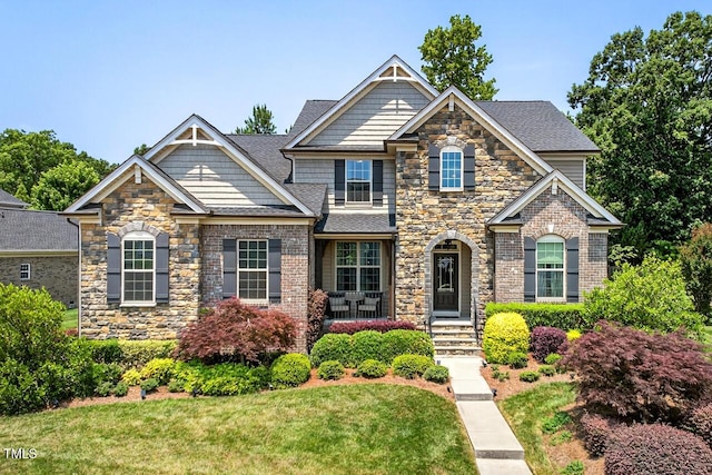 1806 Pattersons Mill Rd, Durham, NC 27703 - craftsman-style house featuring stone siding, a front lawn, brick siding, and roof with shingles