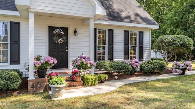 918 Circle Dr, Angier, NC 27501 - doorway to property with a shingled roof, covered porch, and a lawn