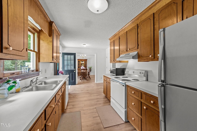 918 Circle Dr, Angier, NC 27501 - kitchen featuring freestanding refrigerator, white electric stove, under cabinet range hood, stainless steel microwave, and light countertops