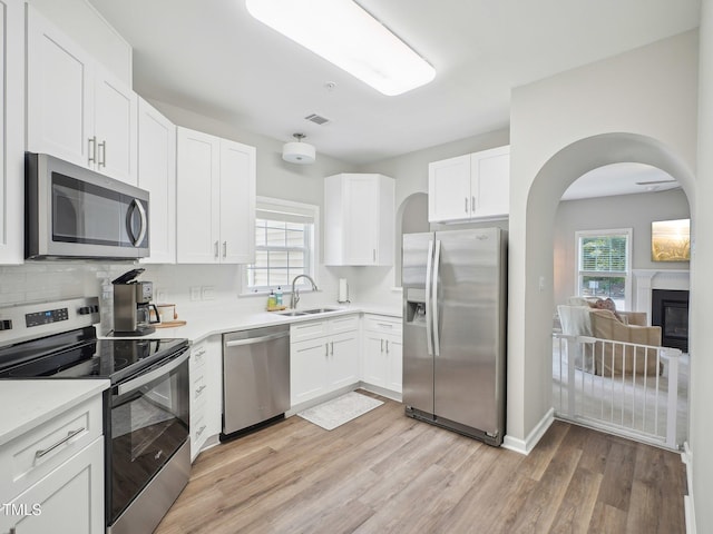 922 Glenolden Ct, Cary, NC 27513 - kitchen with appliances with stainless steel finishes, white cabinetry, light wood finished floors, and light countertops