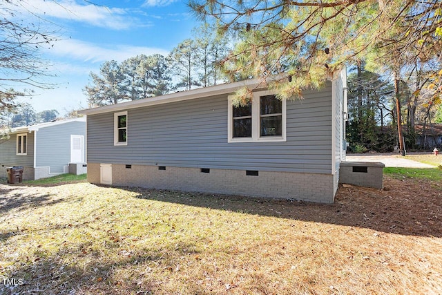 1203 Freeman Dr, Sanford, NC 27330 - view of side of property with crawl space and a lawn