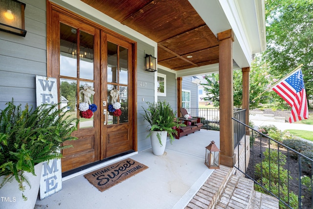 447 Marcellus Way, Clayton, NC 27527 - view of exterior entry featuring covered porch and french doors