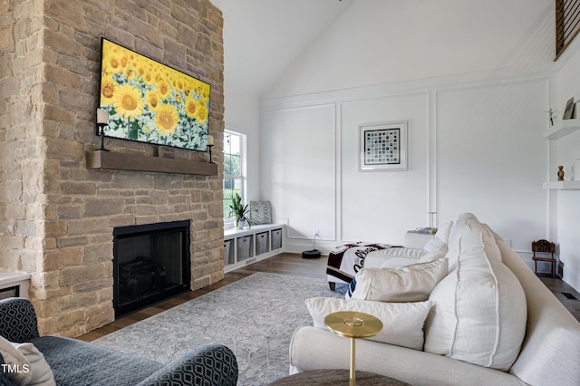 447 Marcellus Way, Clayton, NC 27527 - living room with a large fireplace, wood finished floors, and high vaulted ceiling