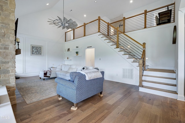 447 Marcellus Way, Clayton, NC 27527 - living area with high vaulted ceiling, wood finished floors, stairway, and a ceiling fan