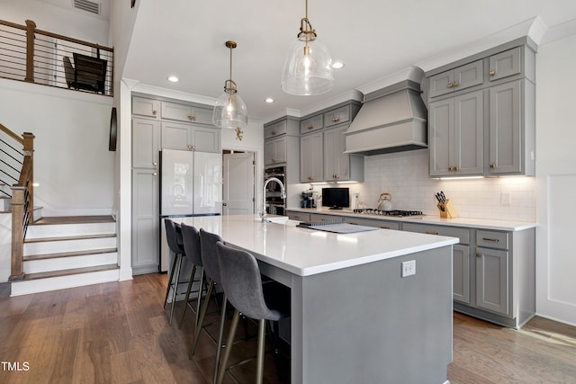 447 Marcellus Way, Clayton, NC 27527 - kitchen featuring gray cabinetry, custom range hood, appliances with stainless steel finishes, and recessed lighting